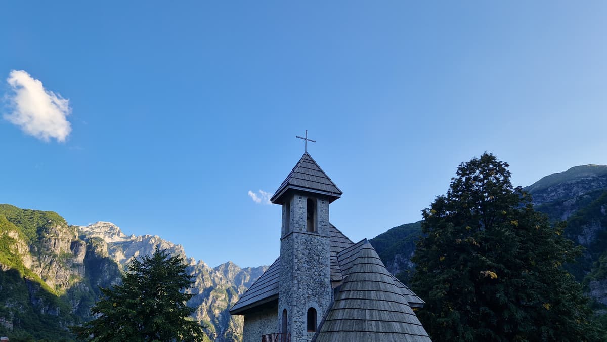 Church in Theth with mountains on the background.