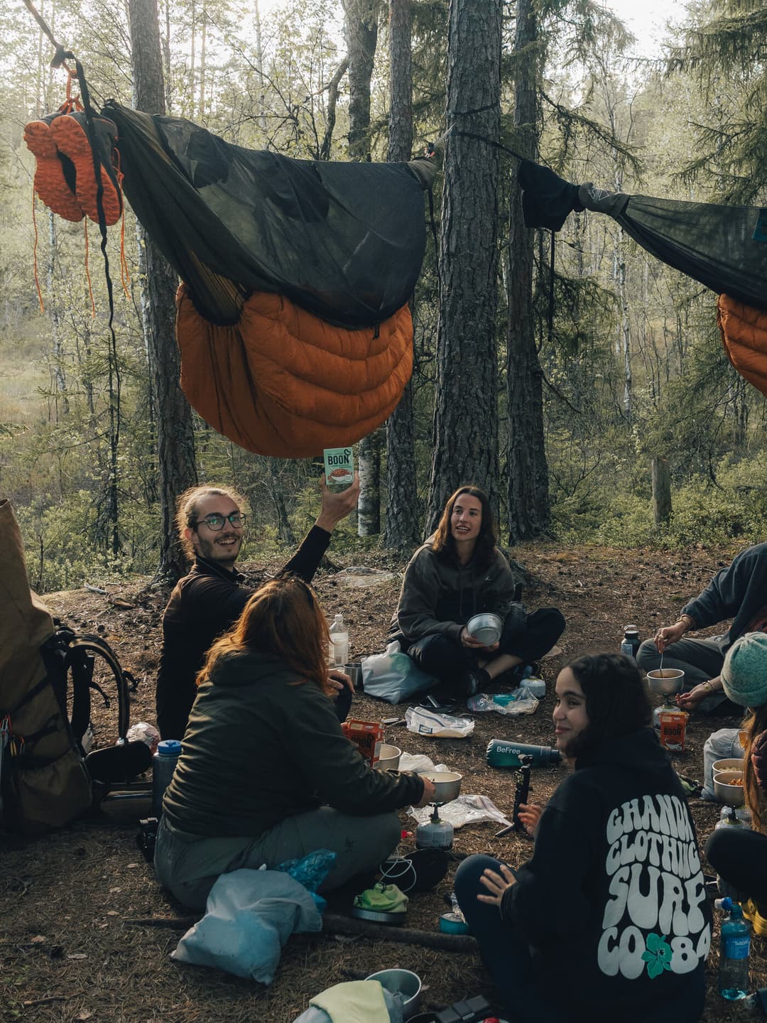 Person showing dinner at hammock camp. Person showing dinner at hammock camp.